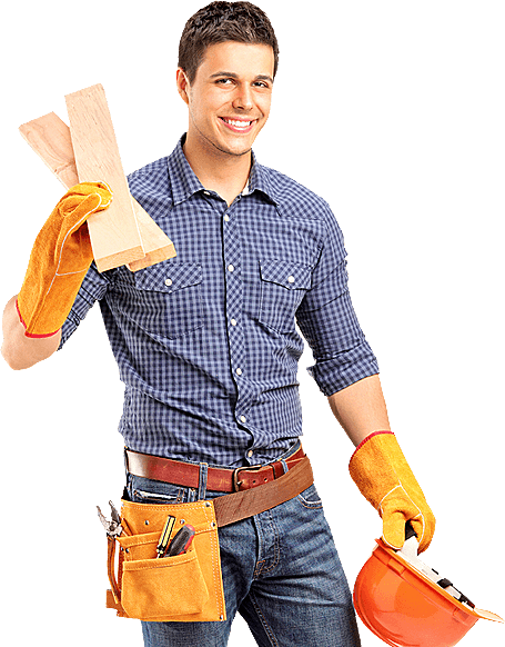 A worker smiling and holding a helmet and a wooden plank.